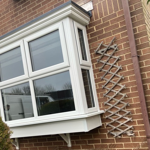 a bay window on a brick house
