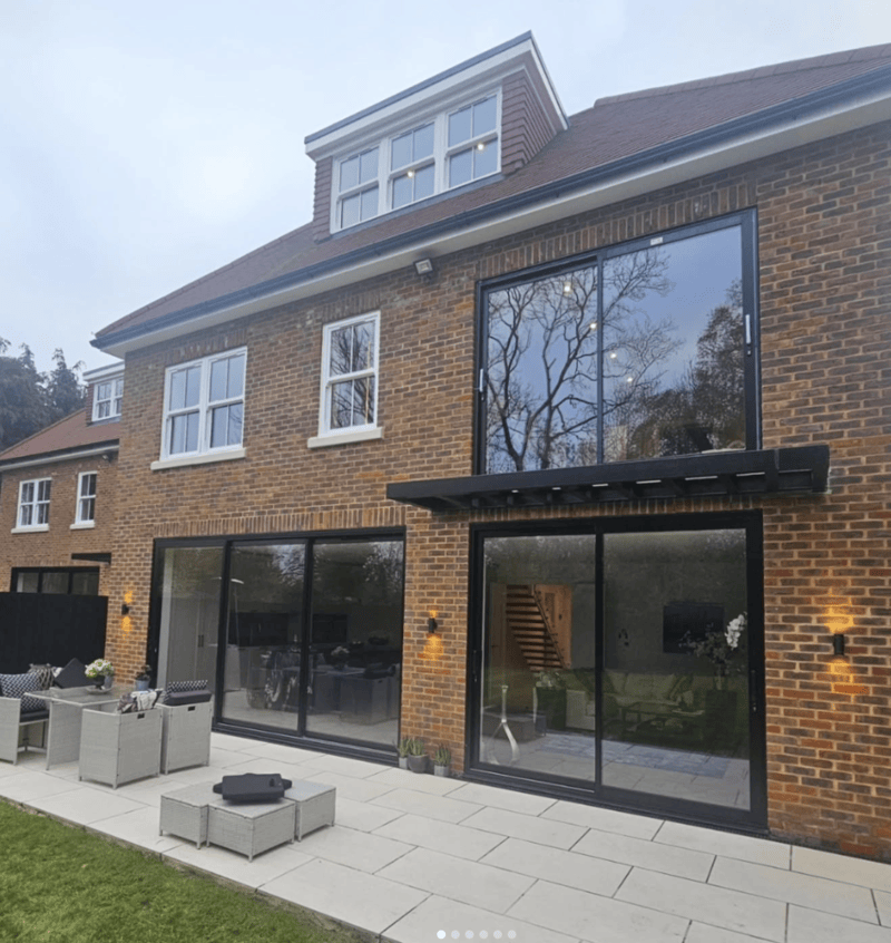 A red brick property with new aluminium doors