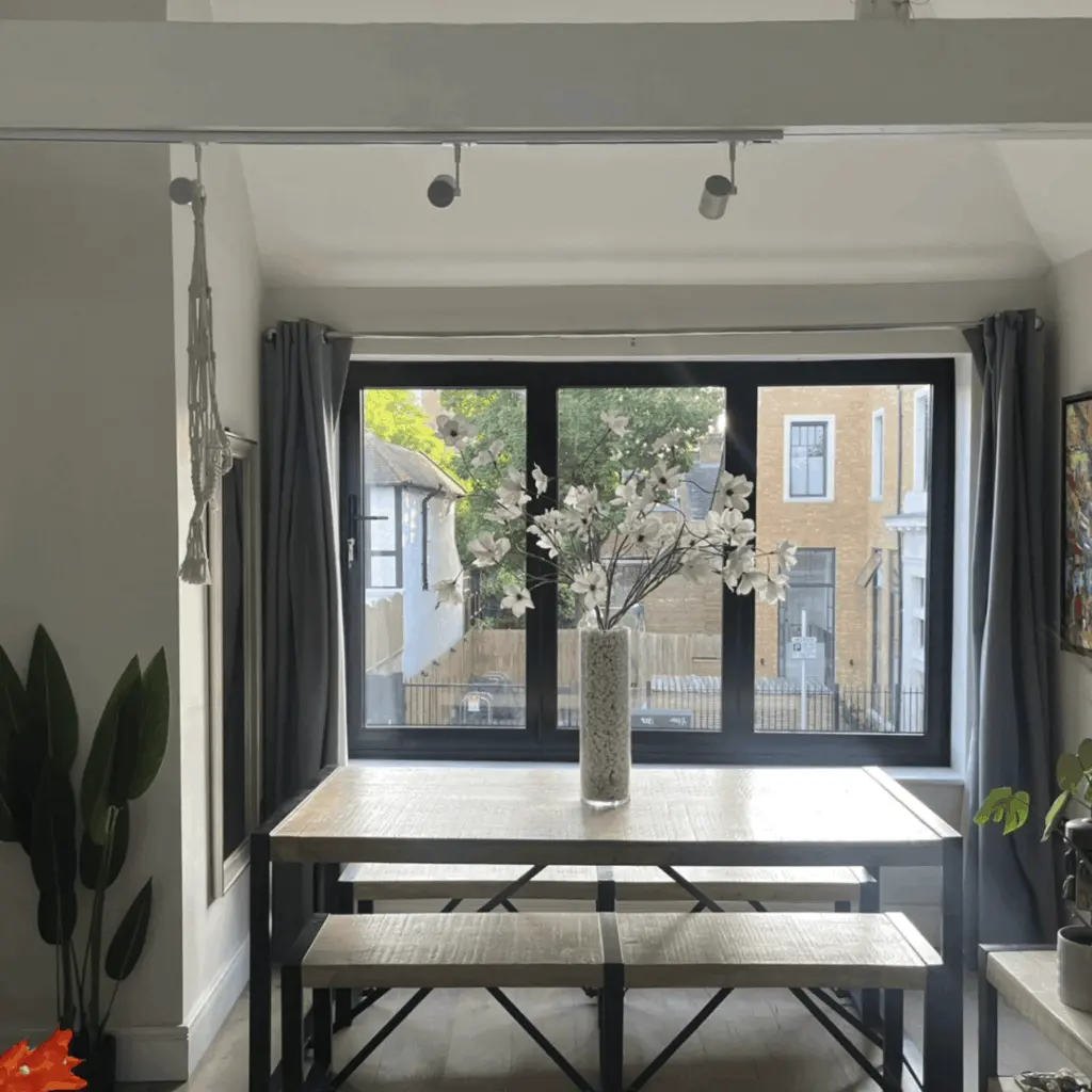 Casement windows with flowers in front of them